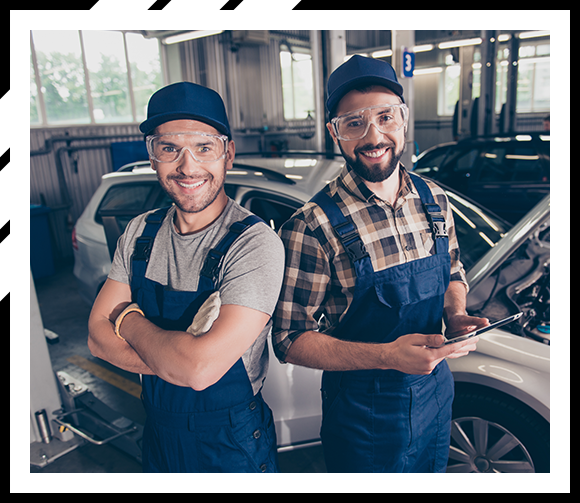 two mechanic in blue in auto shop center